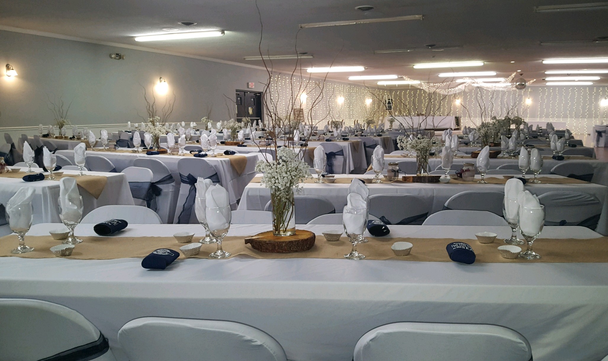 Wedding Reception tables and chairs with table decorations and flowers