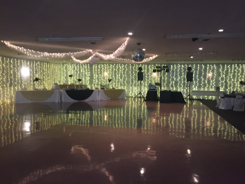 Banquet Hall area for dancing with a disco ball and lights hanging from the ceiling